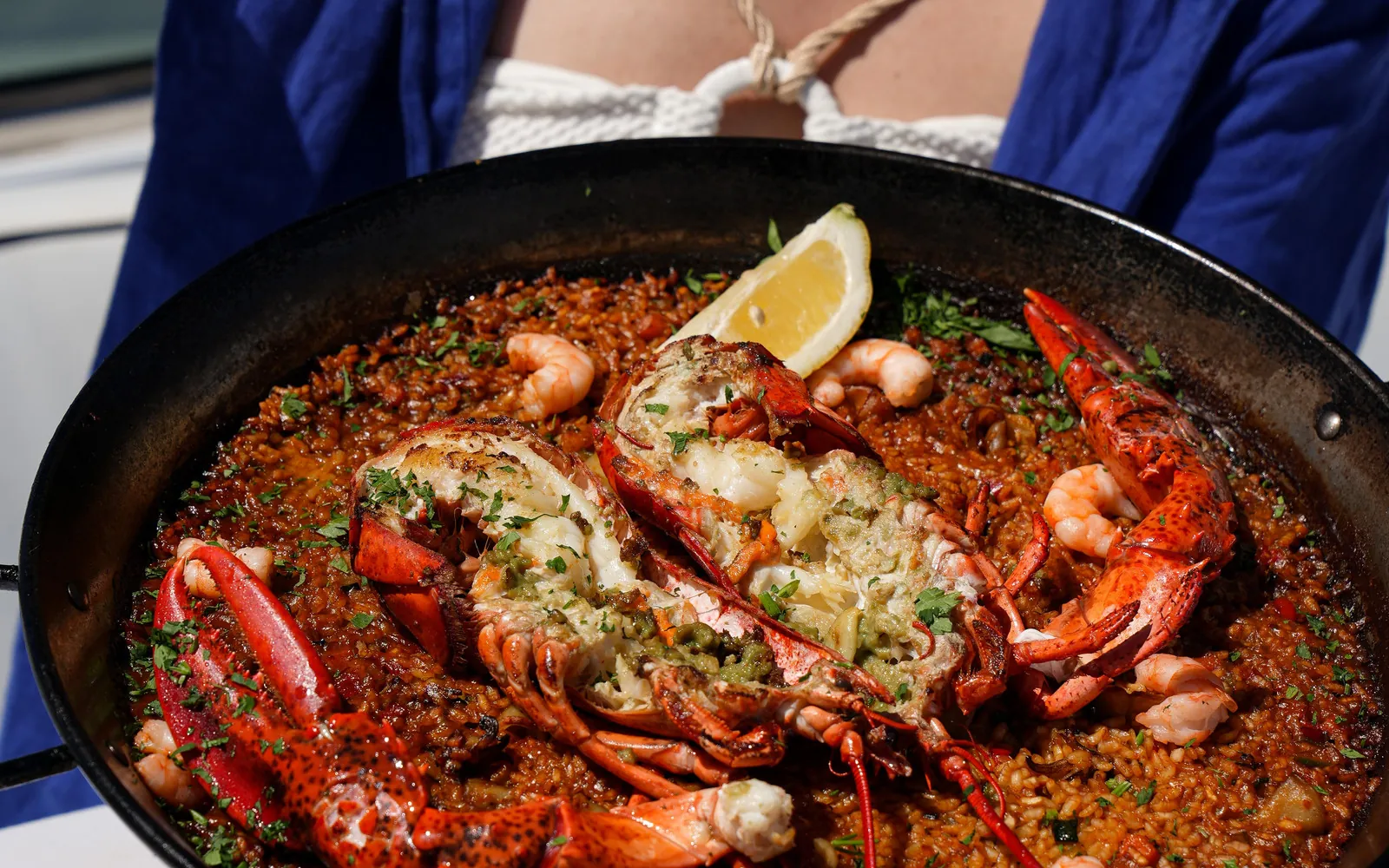 Large seafood paella with lobster served at PiCú Seafood restaurant in Marbella