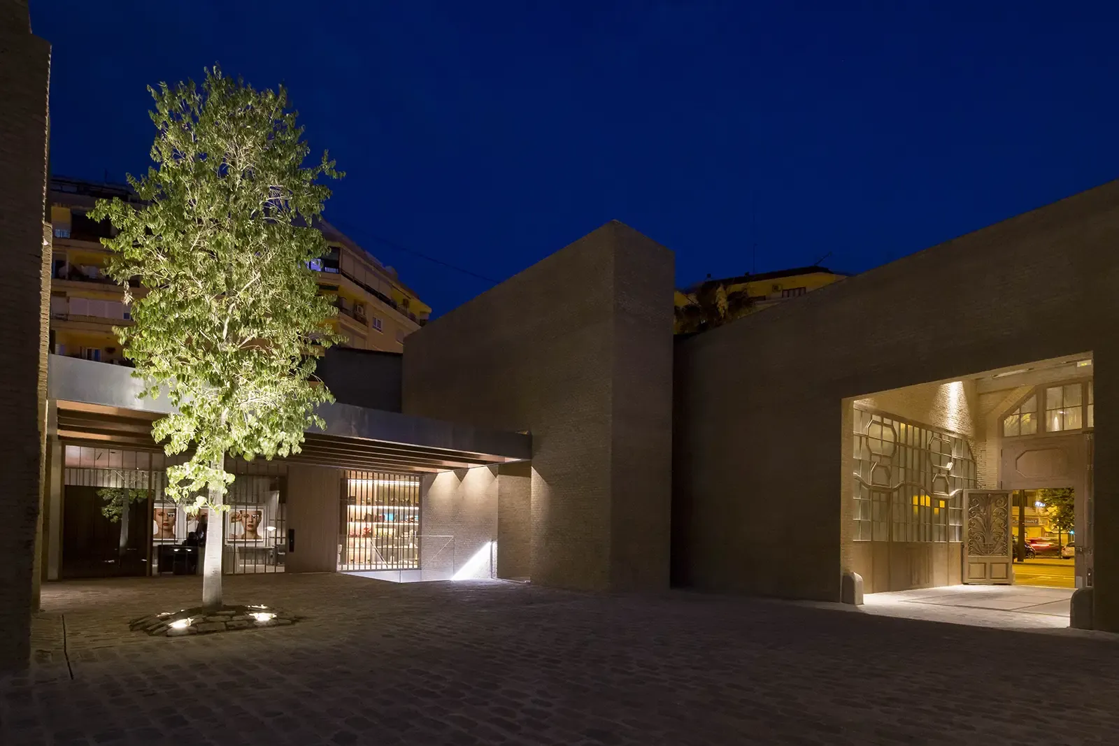 Ricard Camarena restaurant exterior at night in Valencia, illuminated tree and courtyard