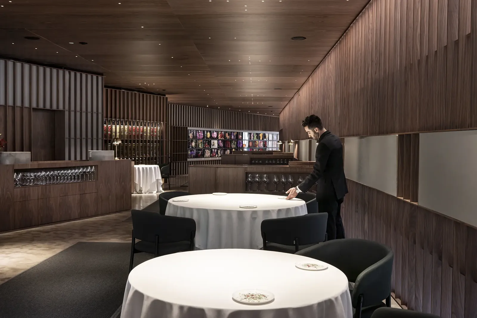 Ricard Camarena restaurant dining room in Valencia, round tables and wooden bar