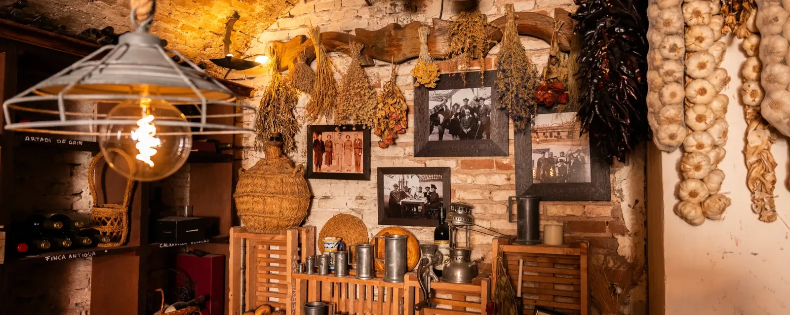Wall décor with framed photos and pendant lamp at Venta de Aires in Toledo
