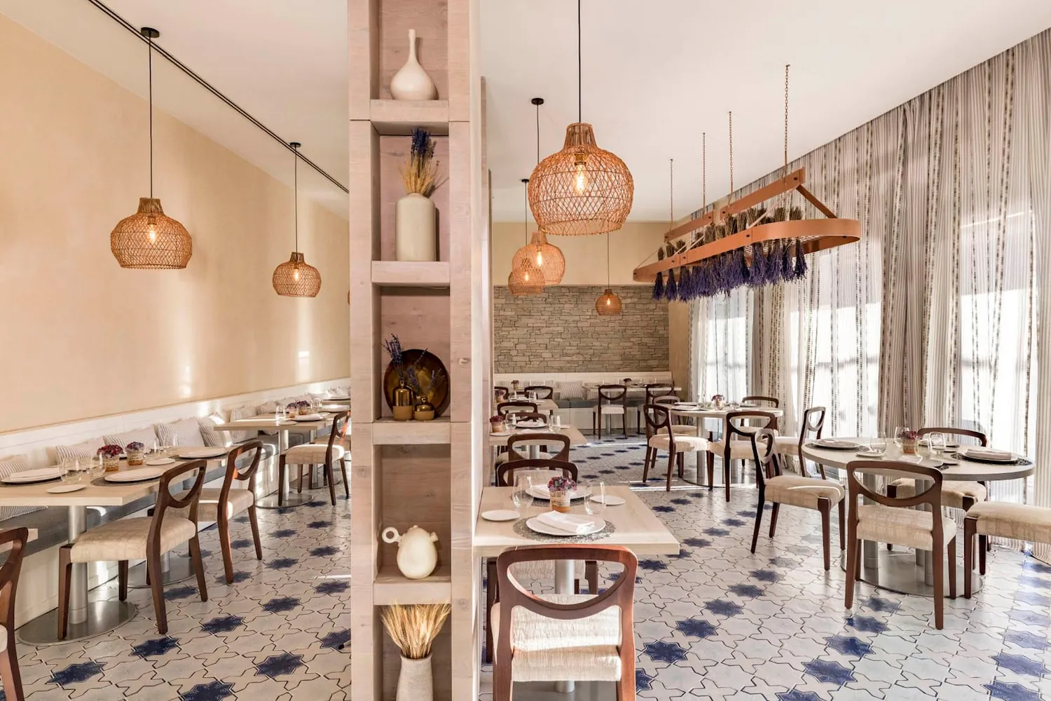 Verema restaurant room in Sitges with wicker pendant lights and wooden tables