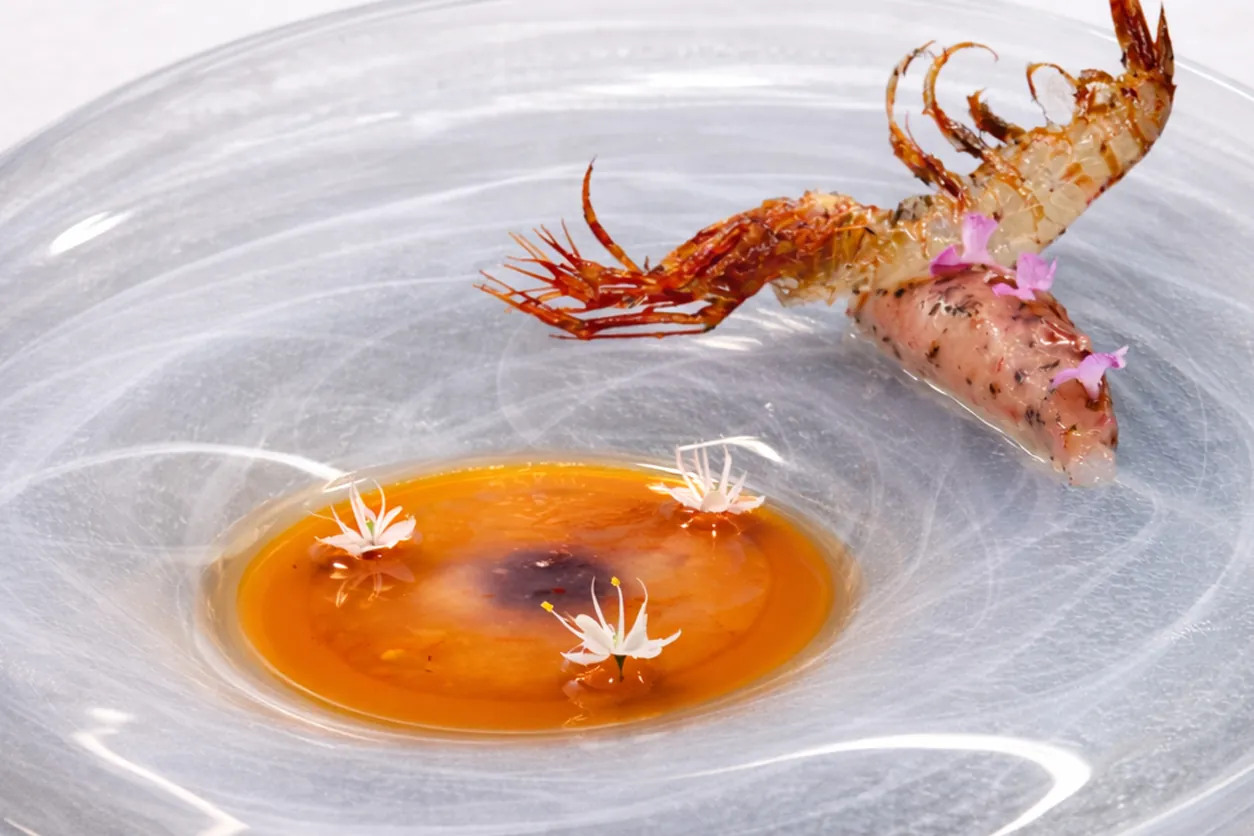 Grilled prawn on clear plate with orange sauce, Zaranda restaurant Palma