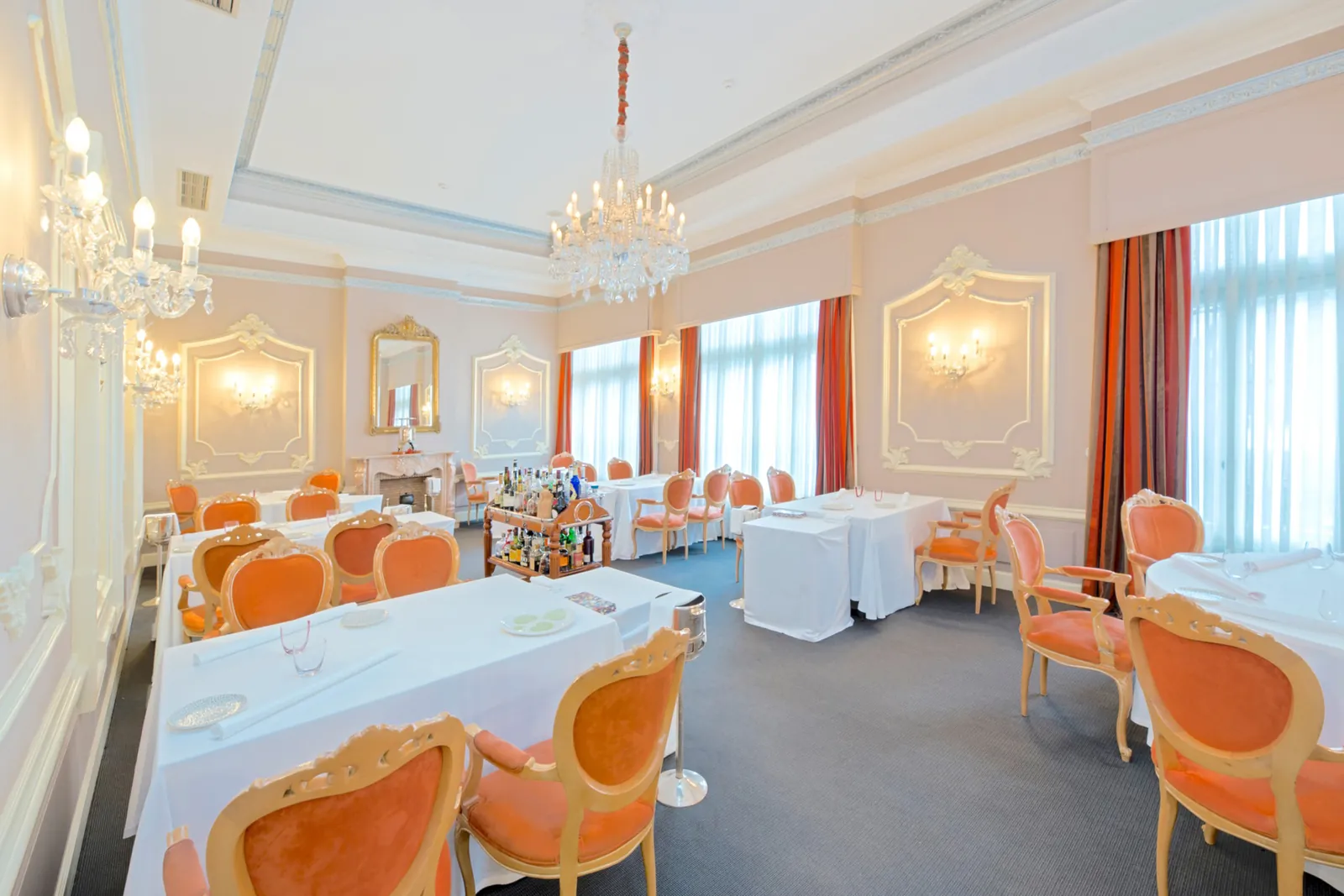 Zortziko restaurant dining room in Bilbao with orange chairs and laid tables