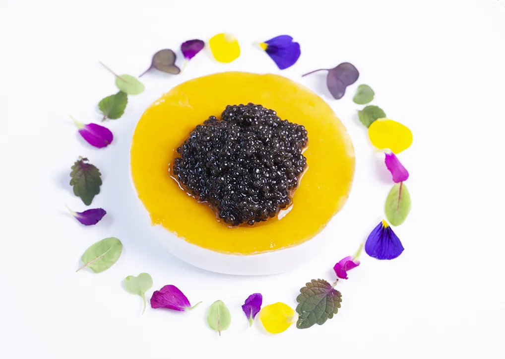 Black caviar on golden cream ringed with edible flowers, Zortziko Bilbao
