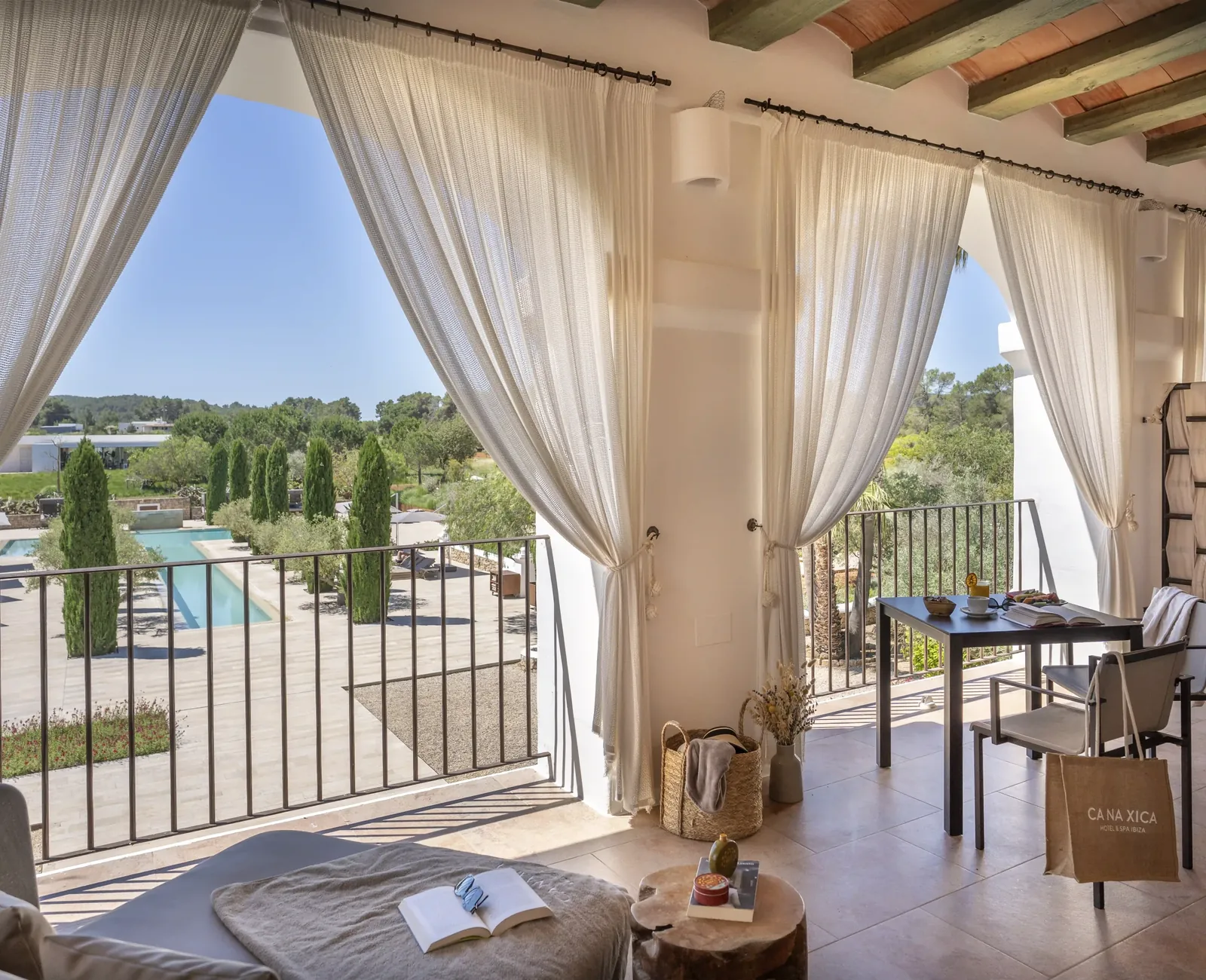 Outdoor space opening onto the estate, white curtains
