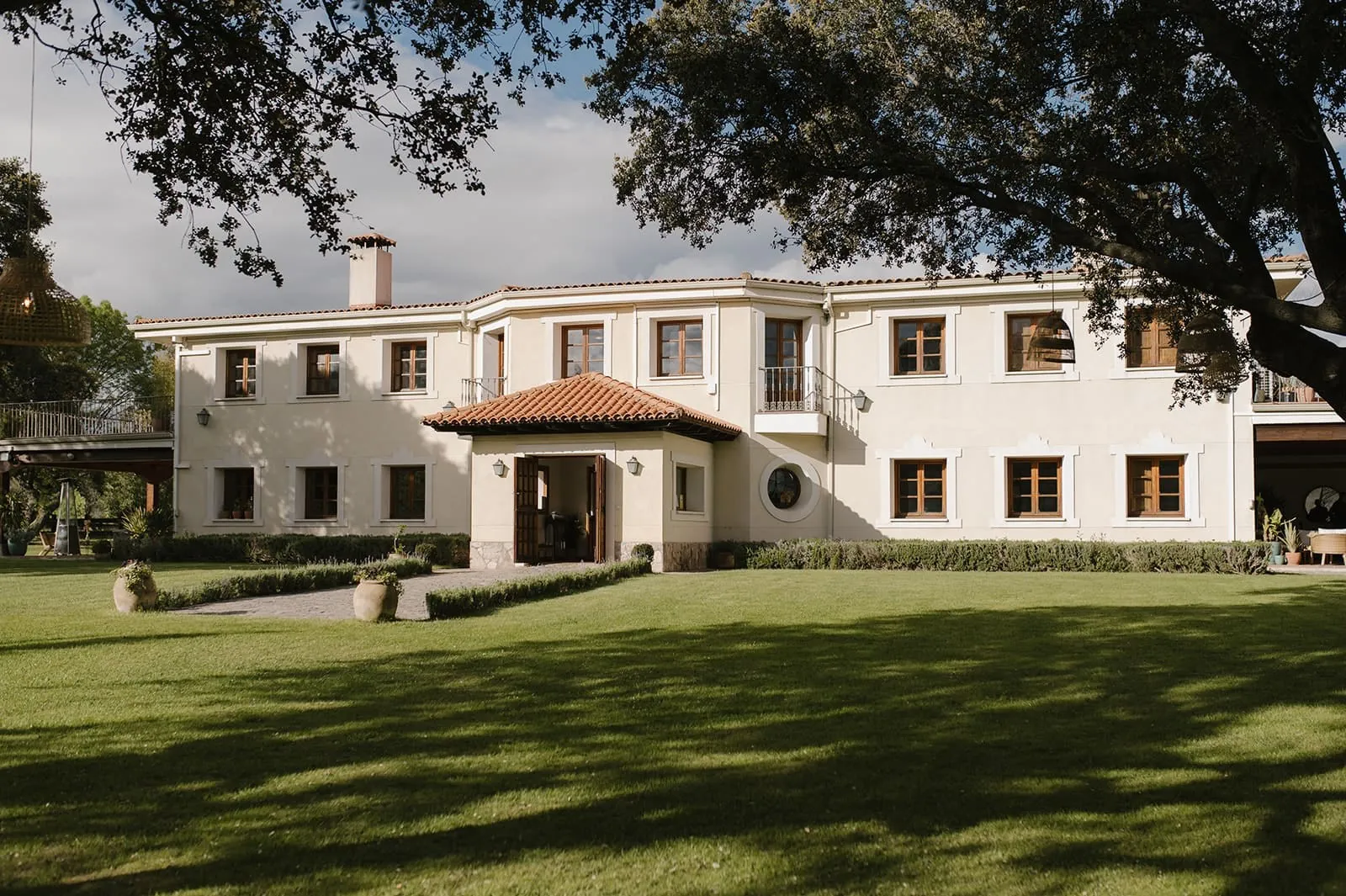 Facade of the Dehesa de Abantos near Madrid, surrounded by oaks and lawn