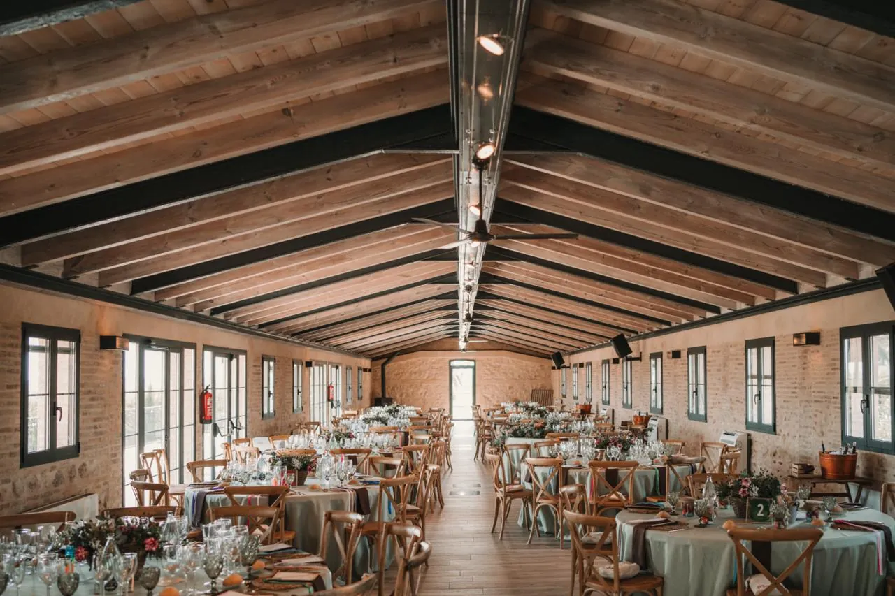Interior hall with wooden beams, set for dinner