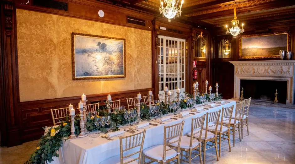 Large wood-panelled dining hall with set table at Finca Mas Solers near Barcelona