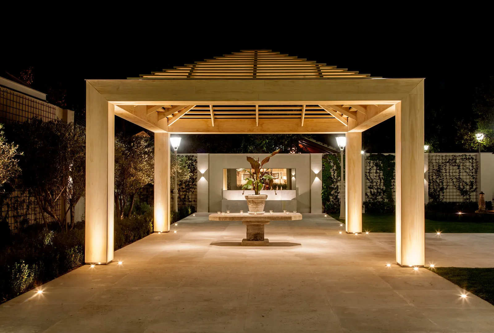 Illuminated pergola in the gardens of Laureana Business Center