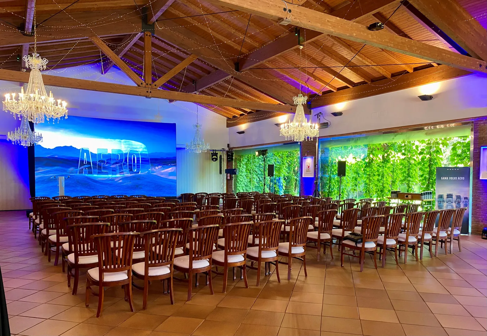 Large salon with stage and screens, set for a convention