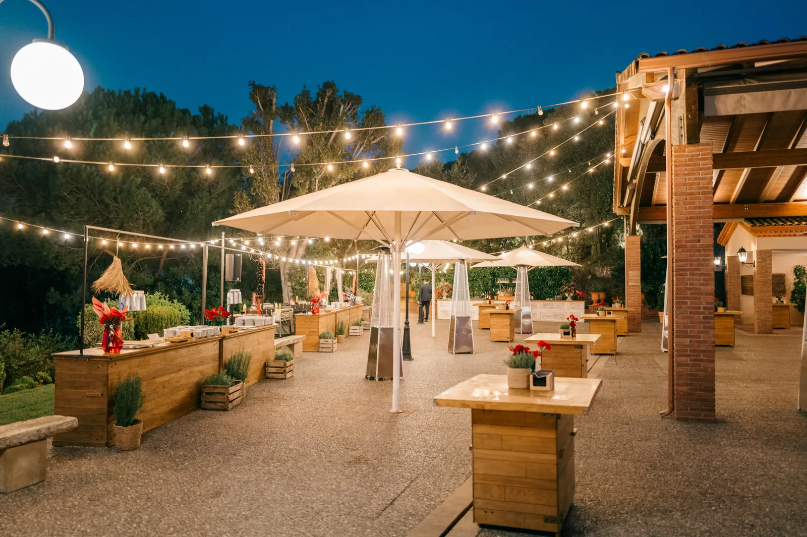 Night-time terrace with bar and festive lighting