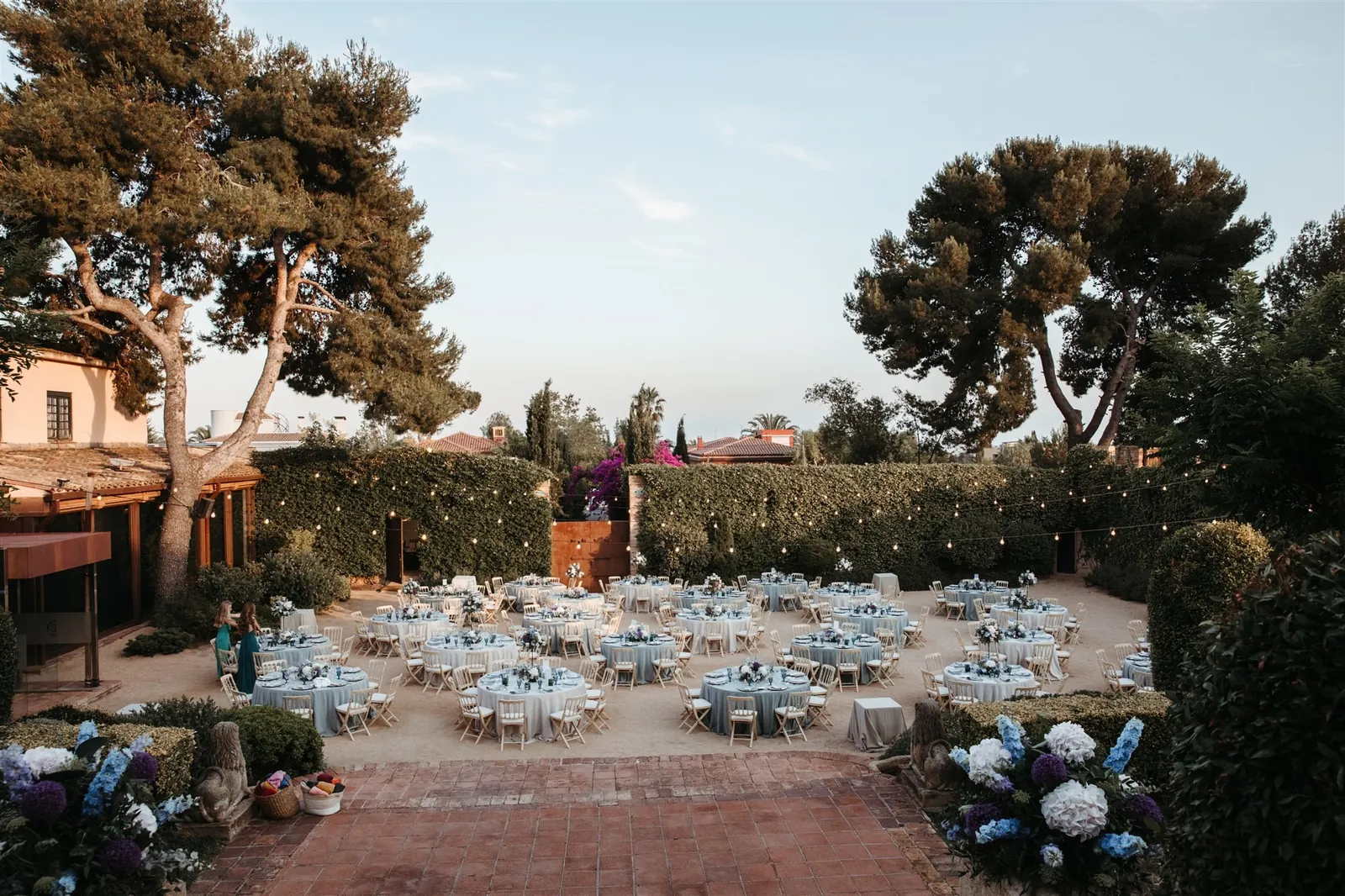 Garden of La Torre dels Lleons with tables set under the pines, Barcelona